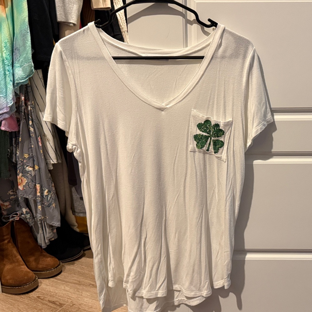 Elegant White V-Neck Tee with Green Clover Accent